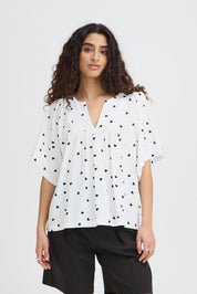 Bluse mit Muster und V - Ausschnitt in schwarz oder weiss - Blossom Hair & Fashion