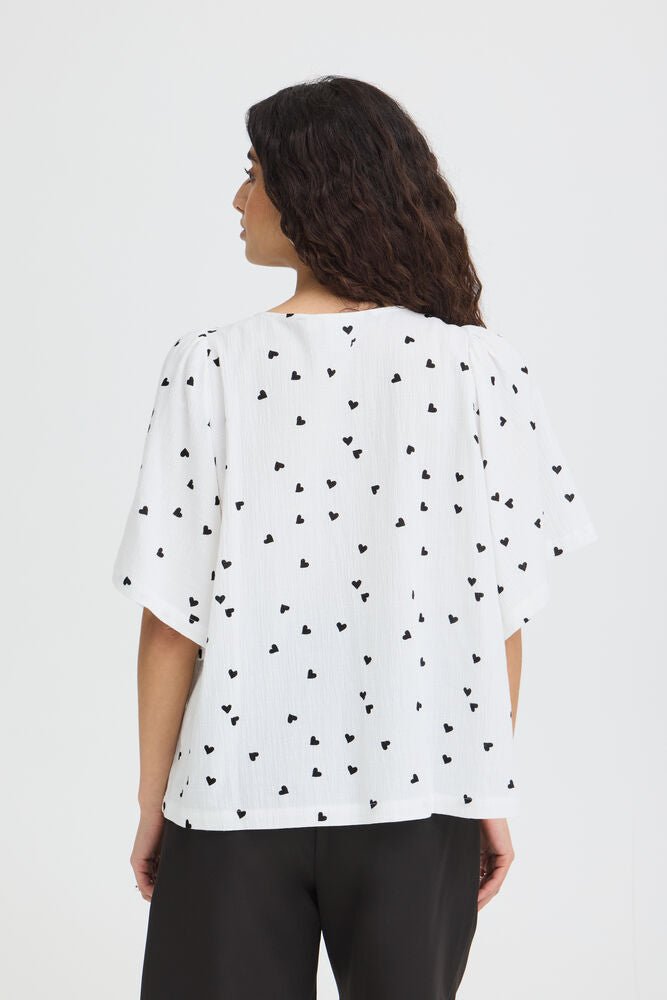Bluse mit Muster und V - Ausschnitt in schwarz oder weiss - Blossom Hair & Fashion